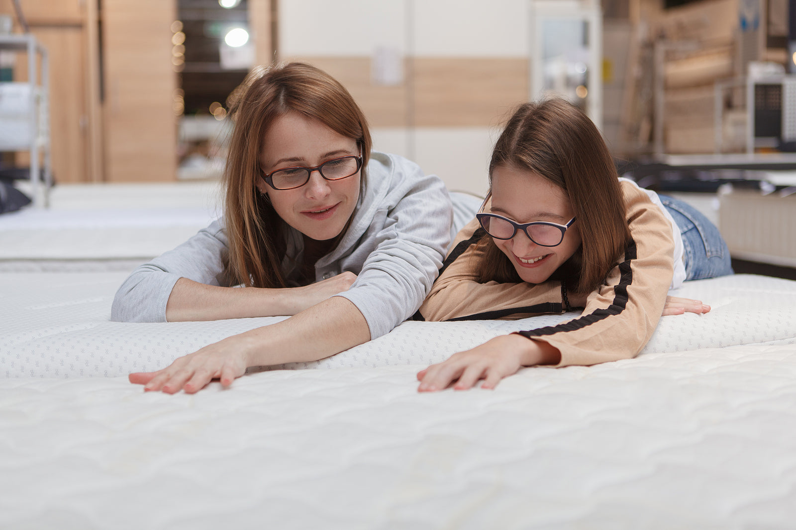 Mother and daughter shopping for mattresses at S&D's Value Store, highlighting affordable quality home furnishings.