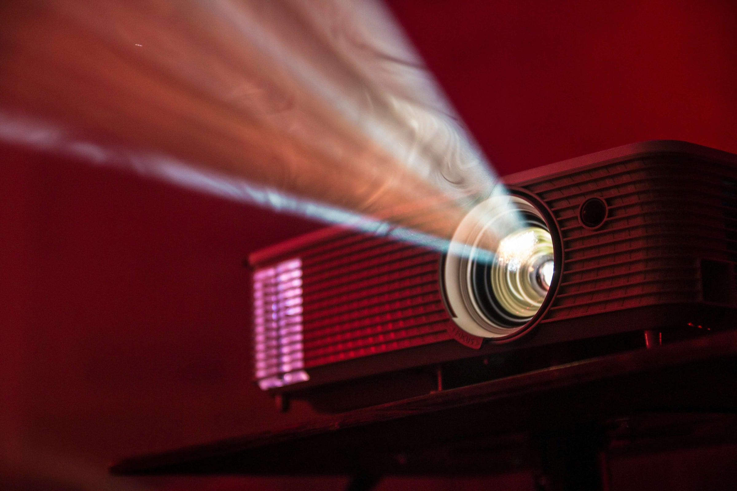 Affordable stylish projector casting bright light, perfect for a budget-friendly home entertainment setup.