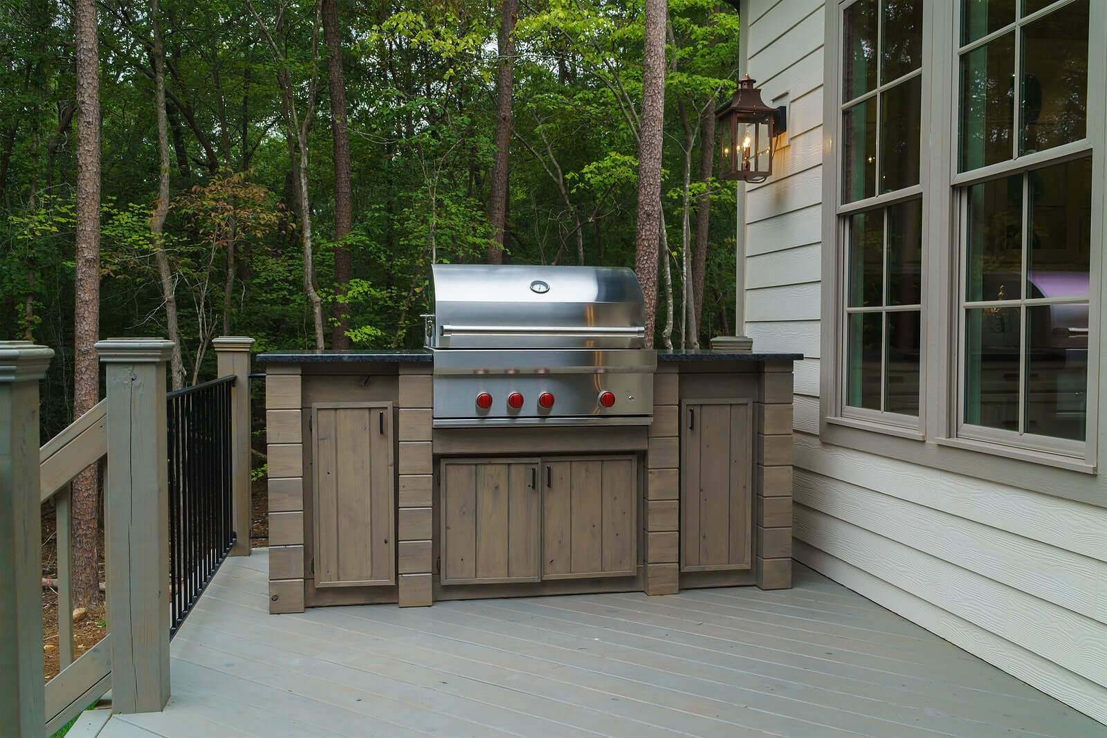 Outdoor stainless steel grill on a wooden deck, ideal for affordable and quality backyard BBQs and grilling sessions.