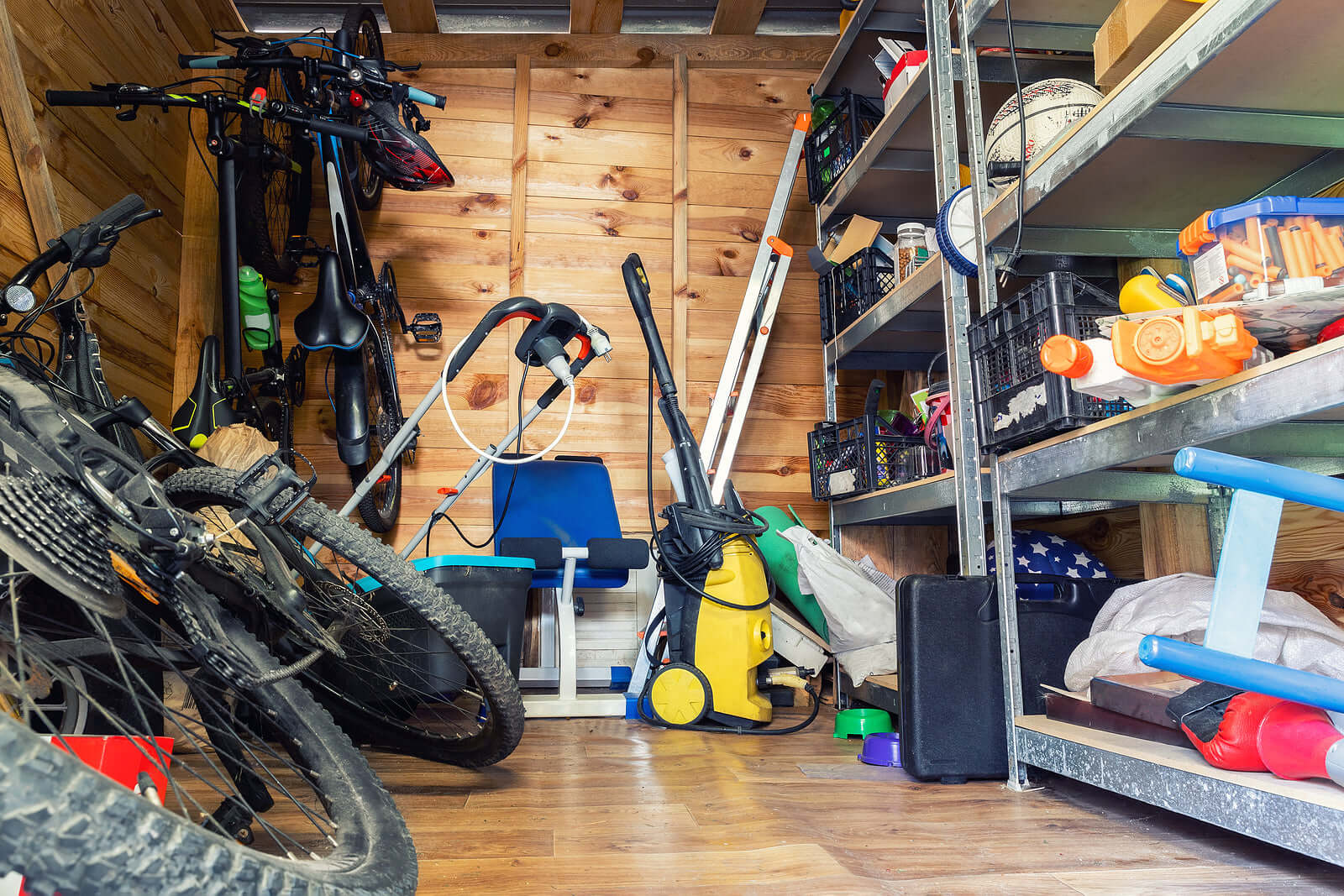 Shed organized with bicycles, garden tools, and equipment, showcasing affordable and stylish storage solutions on a budget.