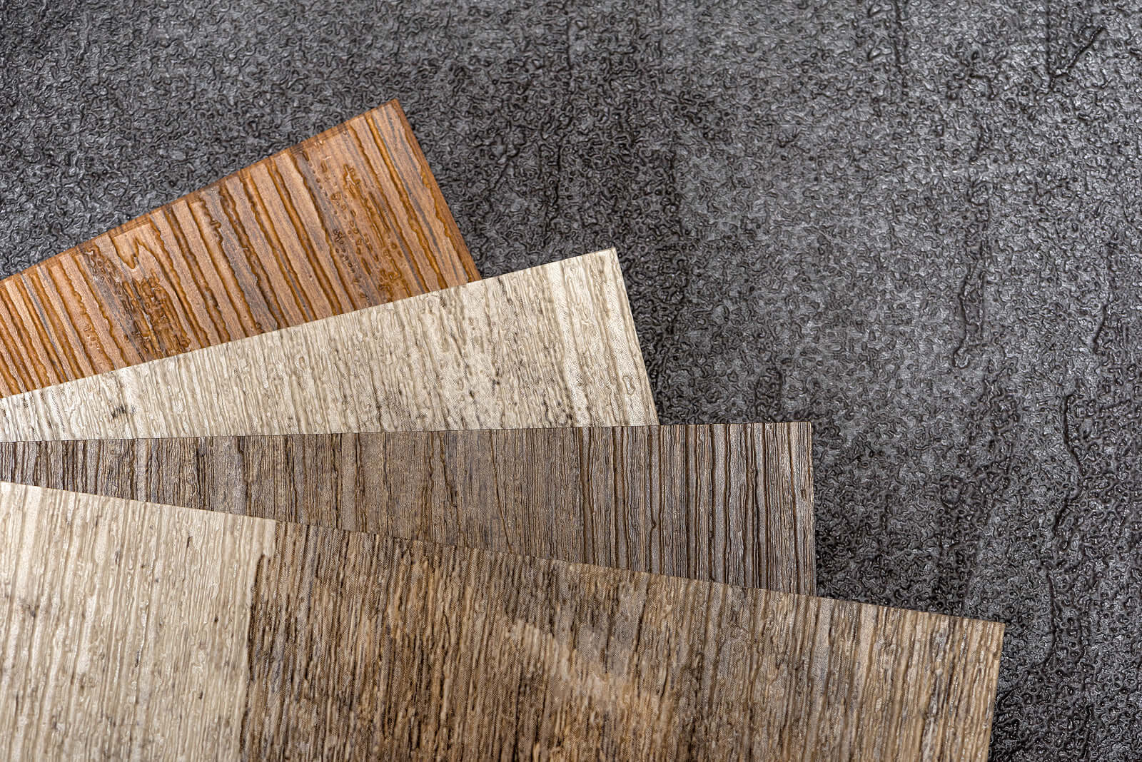 Variety of affordable, high-quality flooring samples including wood and laminate for budget-friendly home renovation.