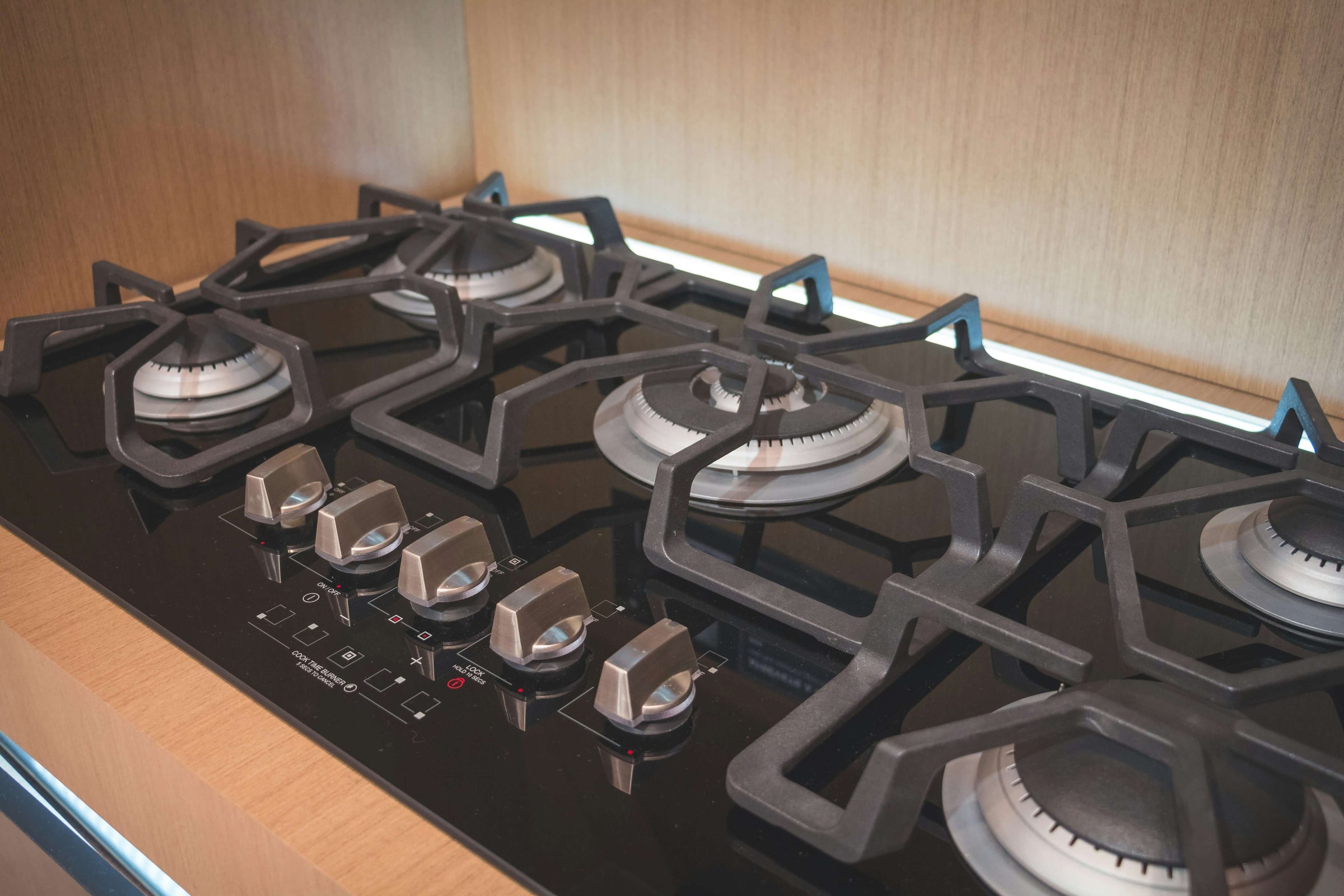 Modern black stovetop with four burners, showcasing affordable, high-quality kitchen appliance from S & D's Value Store.