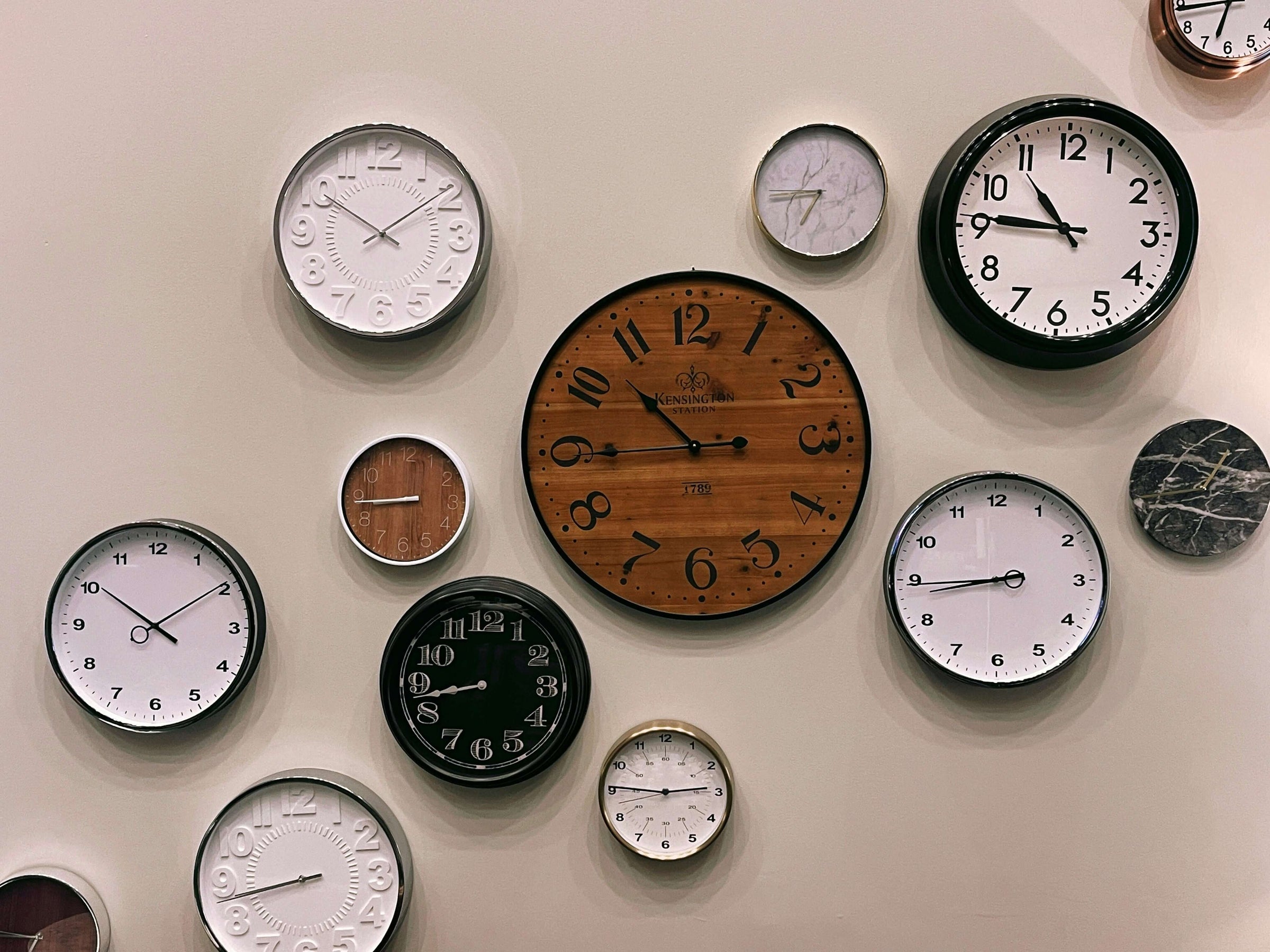 Collection of stylish, budget-friendly clocks on a wall, showcasing quality designs from S & D's Value Store.