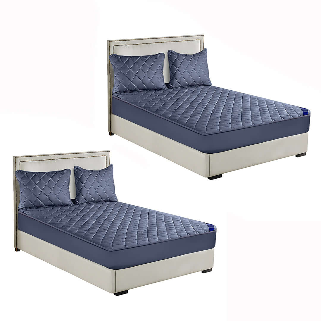 Affordable quality homewares value furniture featuring two modern beds with blue quilted bedding and coordinated pillows.