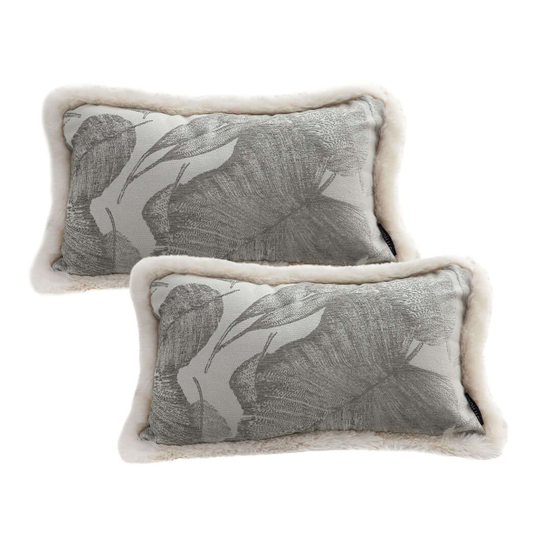 Two affordable, quality homewares cushions with grey leaf print and fur trim, perfect for adding value and comfort to your furniture.