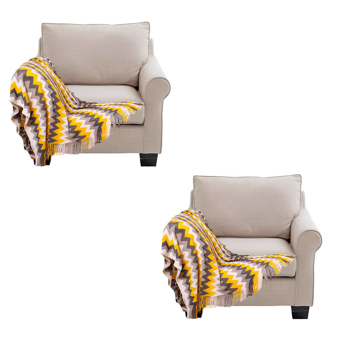 Affordable quality armchairs with colorful zigzag blankets, perfect for value furniture and stylish homewares.