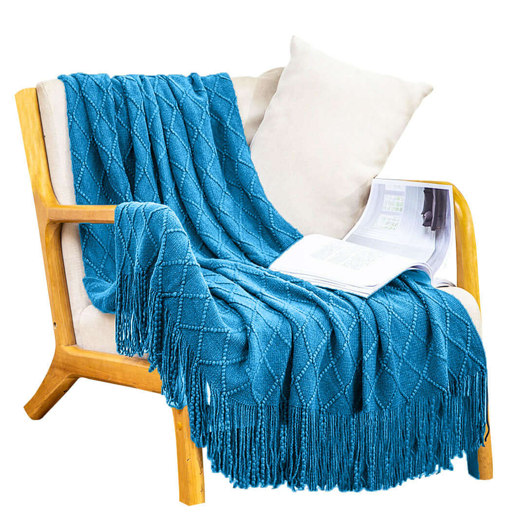 Cozy chair with a turquoise knitted throw blanket and a magazine, highlighting affordable homewares and quality value furniture.