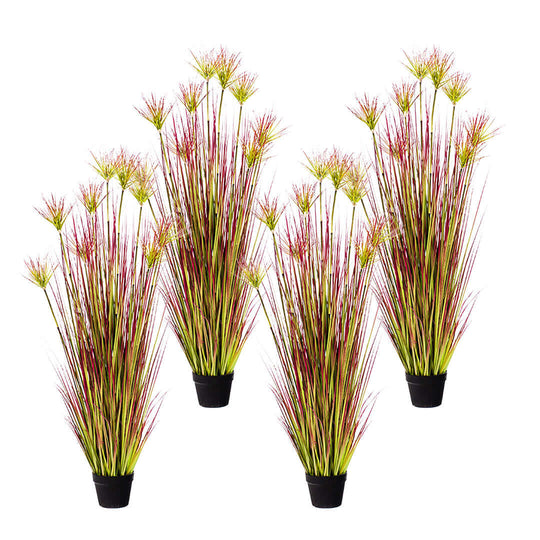 Four artificial decorative plants with tall green and red grass in black pots.