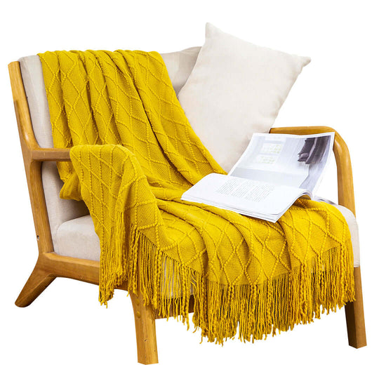 Affordable quality homewares - cozy armchair with yellow knitted throw and magazine, showcasing value furniture.