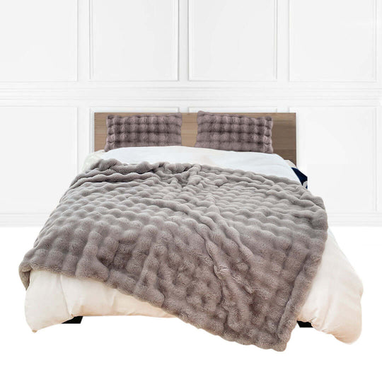 Plush bed with grey textured blanket and matching pillows, showcasing affordable homewares and quality value furniture.