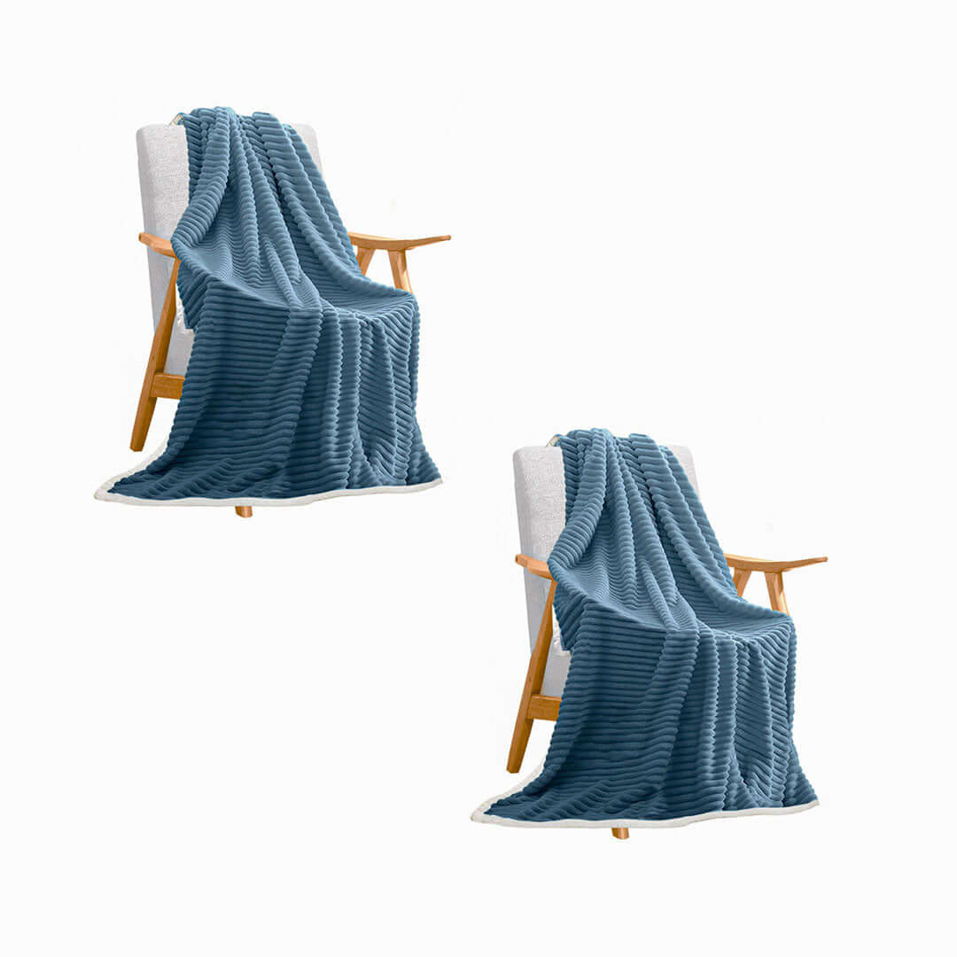 Affordable quality homewares - two blue knitted blankets draped over wooden chairs for value furniture.