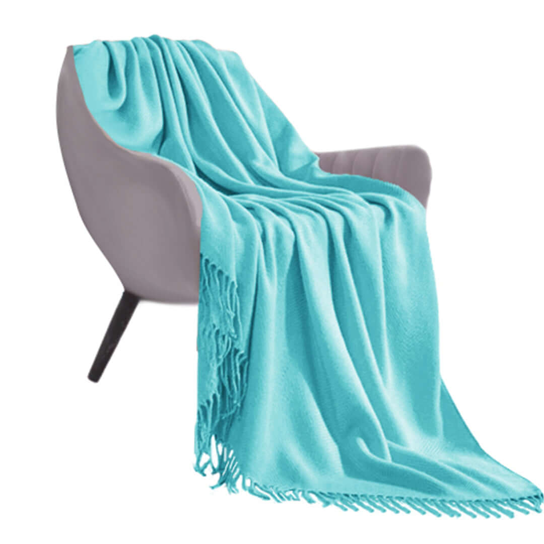 Light blue blanket draped over modern gray chair showcasing affordable homewares, quality and value furniture.