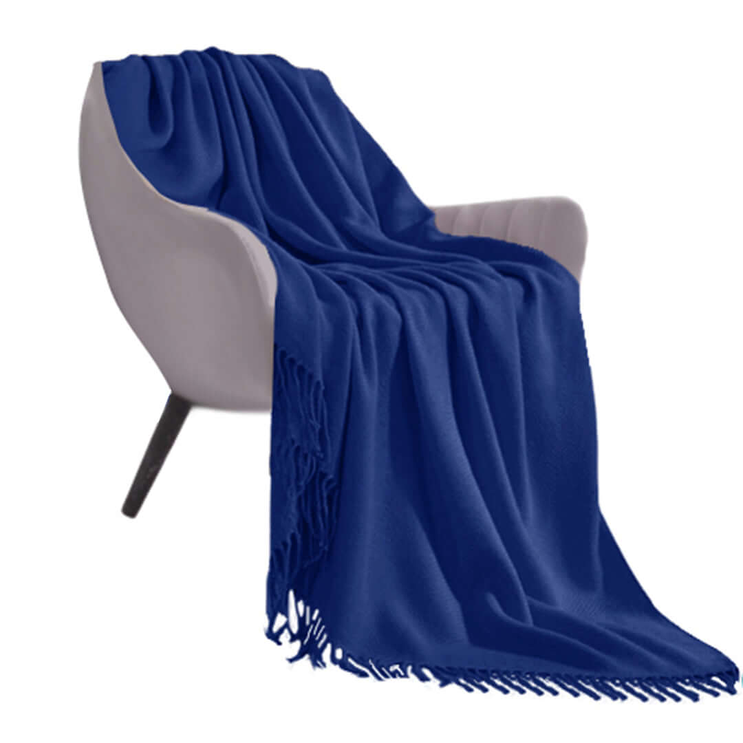 Stylish blue throw blanket draped over a modern grey armchair, showcasing quality and affordable homewares for value furniture.