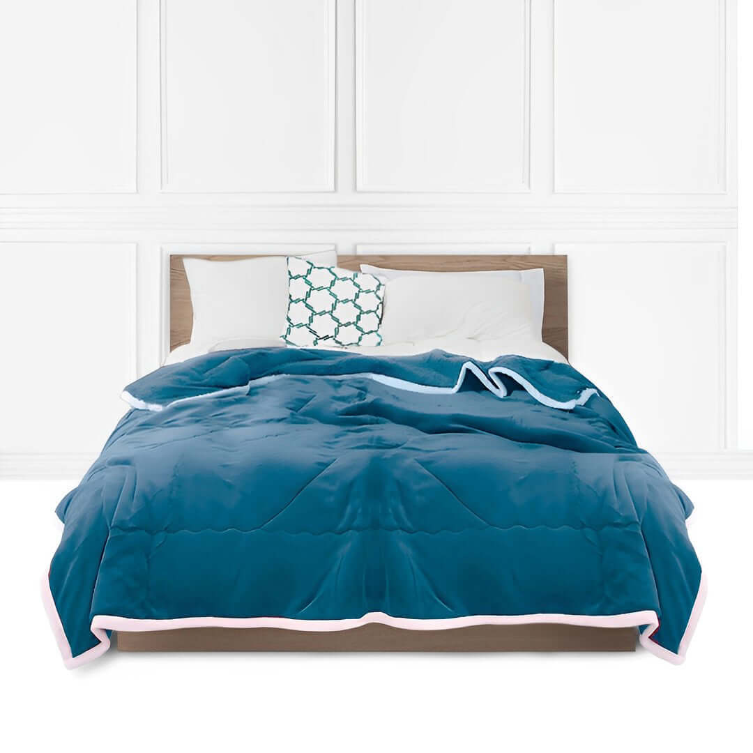 Affordable quality homewares and value furniture featuring a stylish blue bedspread on a modern wooden bed with white pillows and a patterned cushion.