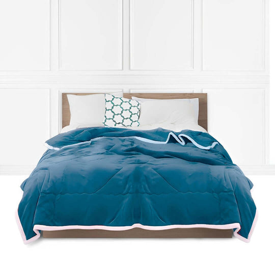 Affordable quality homewares and value furniture featuring a stylish blue bedspread on a modern wooden bed with white pillows and a patterned cushion.