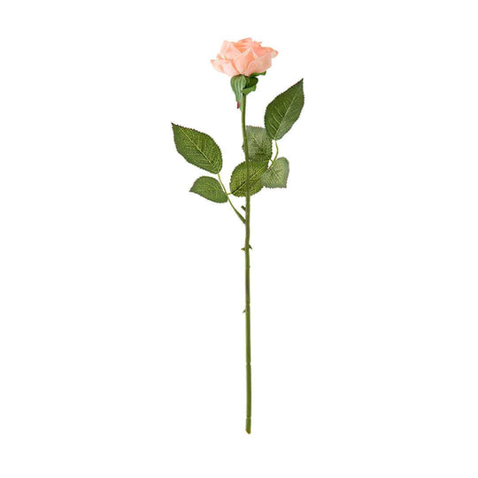 Single artificial blush pink rose on a long stem with green leaves