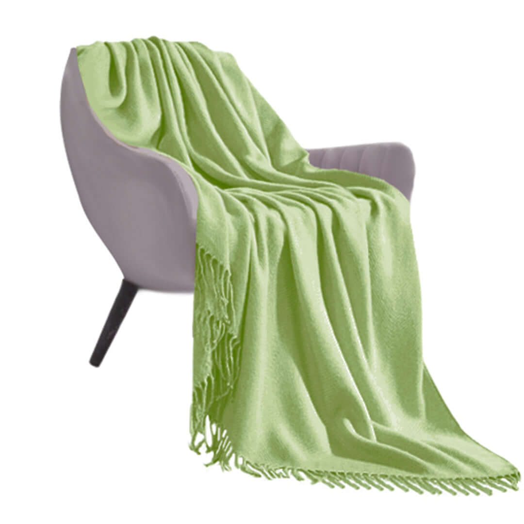 Lime green throw blanket draped over a modern gray chair, perfect for affordable homewares, showcasing quality and value furniture.