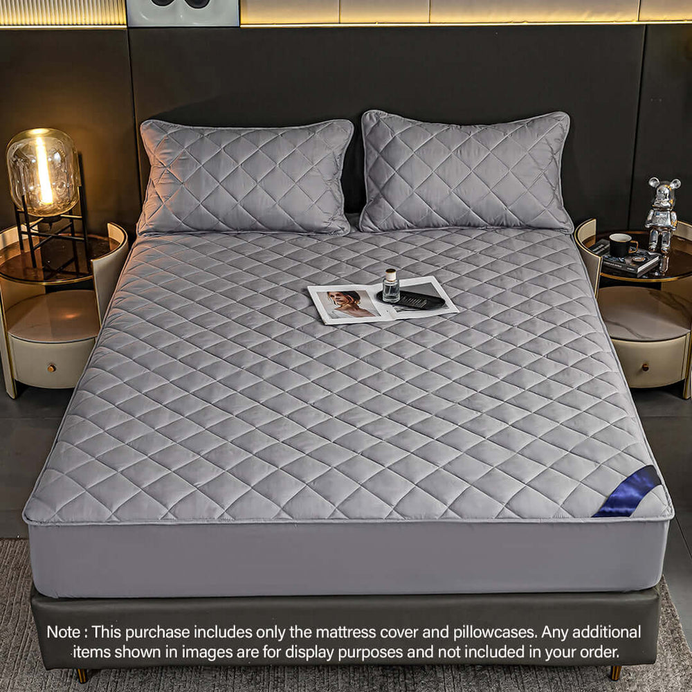 Affordable quality bed with grey quilted mattress cover and pillows in stylish home setting, perfect value furniture for homewares.