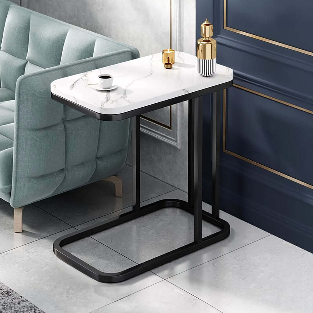 Affordable modern side table with marble top and black base, placed beside a teal tufted armchair, highlighting quality homewares and value furniture.