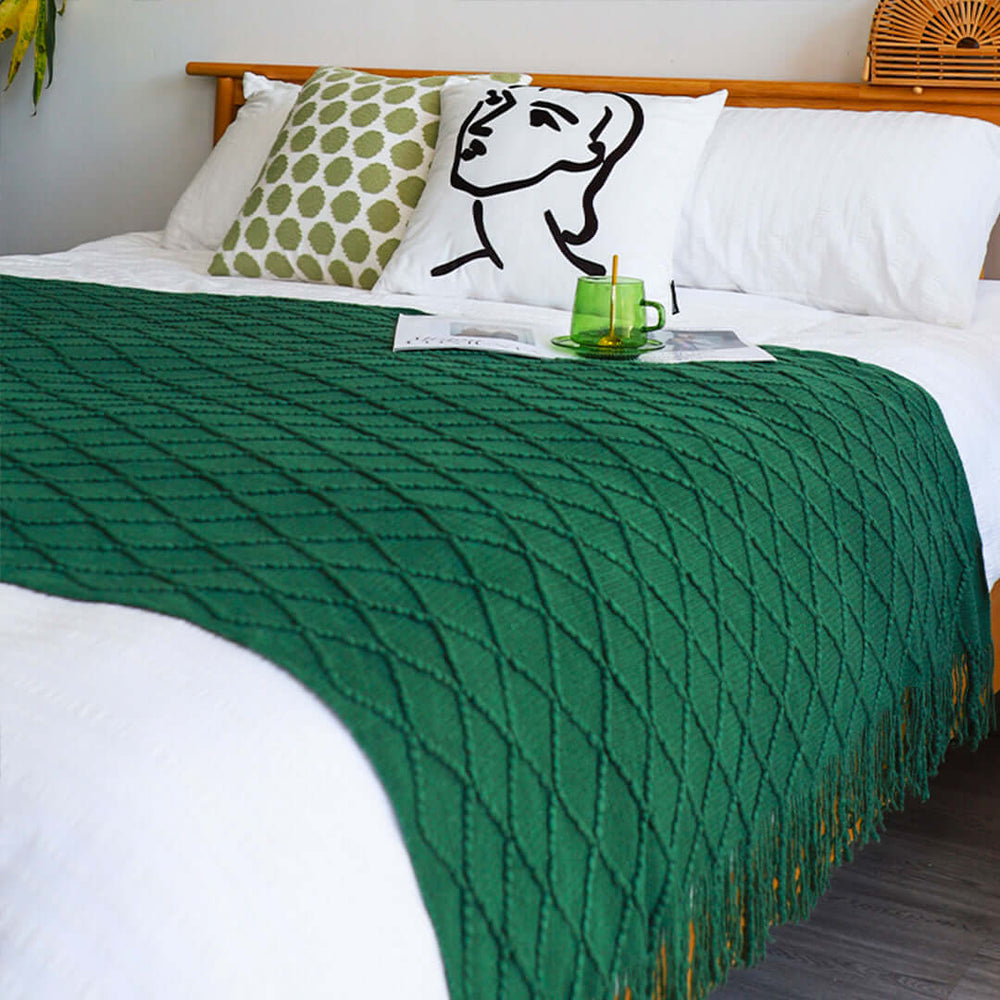 Affordable and quality homewares, featuring a stylish green blanket on a bed with white pillows and modern decorative design.