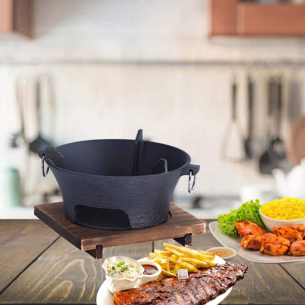 Affordable quality cast iron cookware in a home kitchen with a tray of value home-cooked food including ribs, fries, and side dishes.