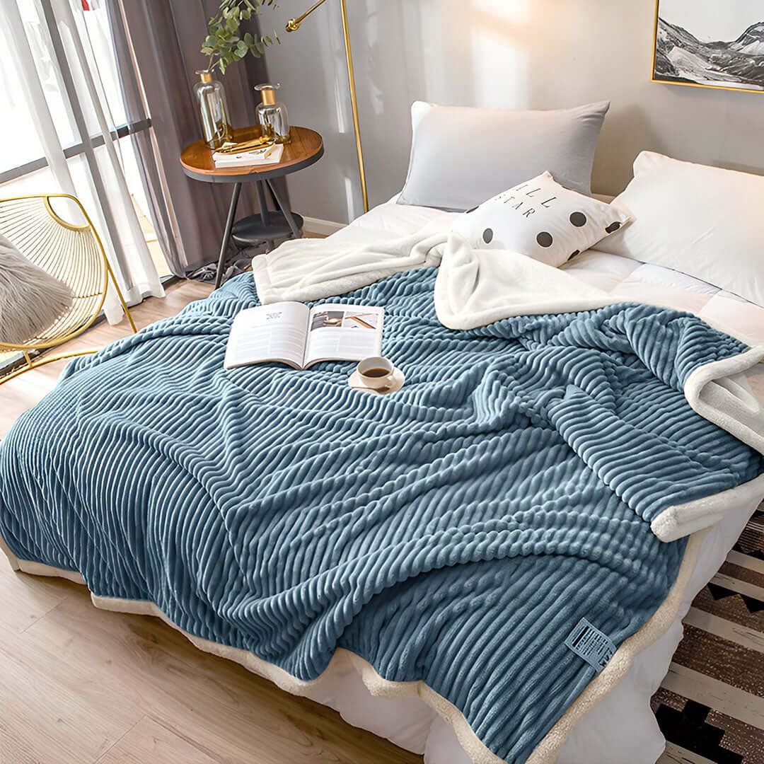 Elegant bed setup featuring a cozy blue ribbed blanket, showcasing affordable homewares with quality and value furniture for a stylish bedroom.