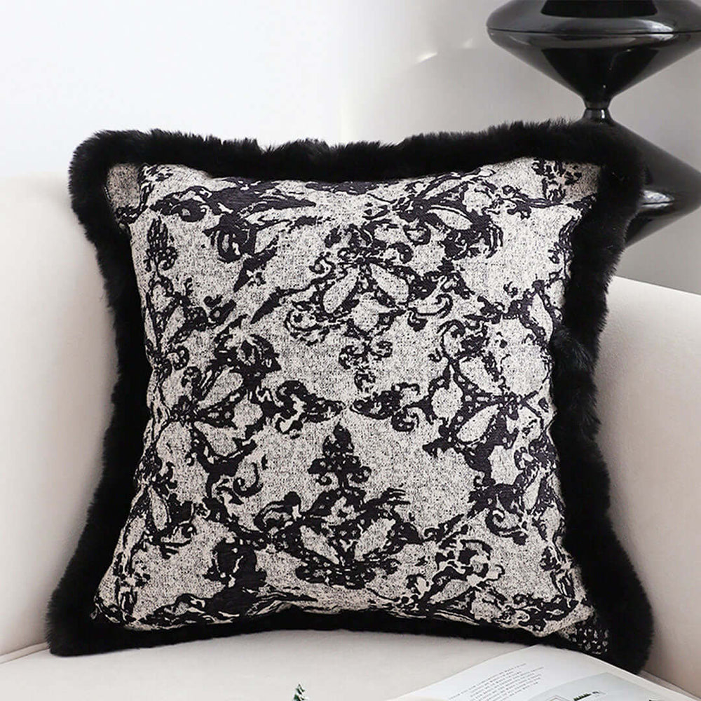 Affordable quality homewares - elegant black and white decorative pillow with black trim, placed on a cream sofa for stylish value furniture.