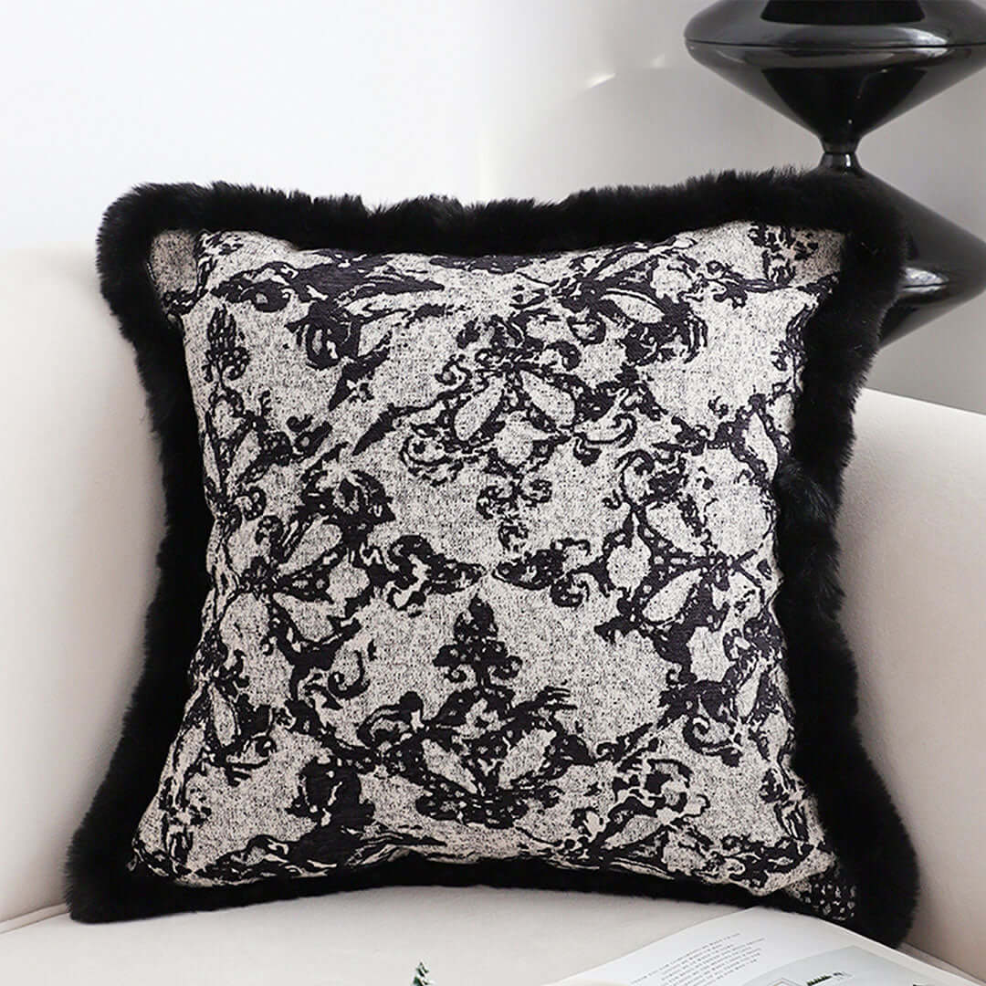 Affordable quality homewares - elegant black and white decorative pillow with black trim, placed on a cream sofa for stylish value furniture.