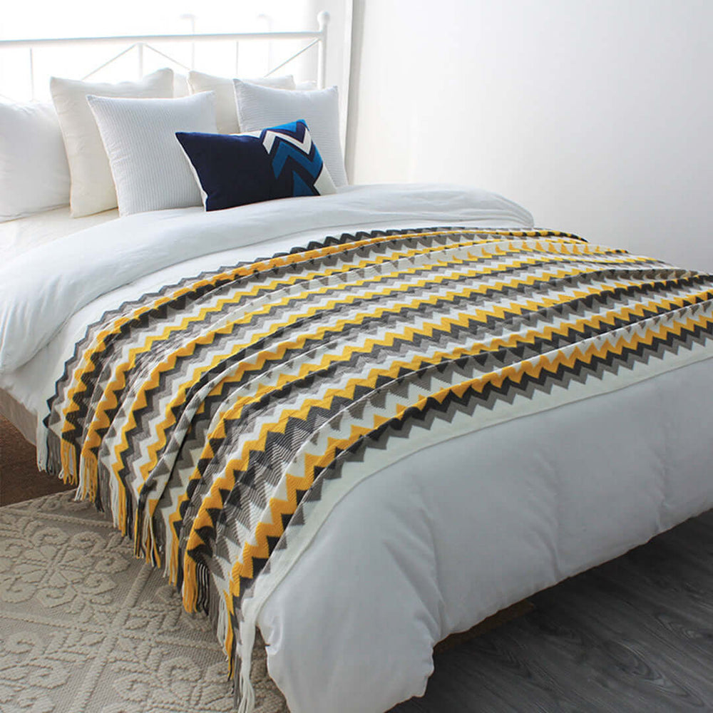 Affordable quality bedding with a stylish zigzag patterned throw on a cozy bed, showcasing value homewares and furniture.