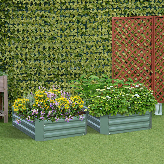 Metal raised garden beds with vibrant flowers and lush plants against a leafy green wall and lattice, perfect for affordable homewares.