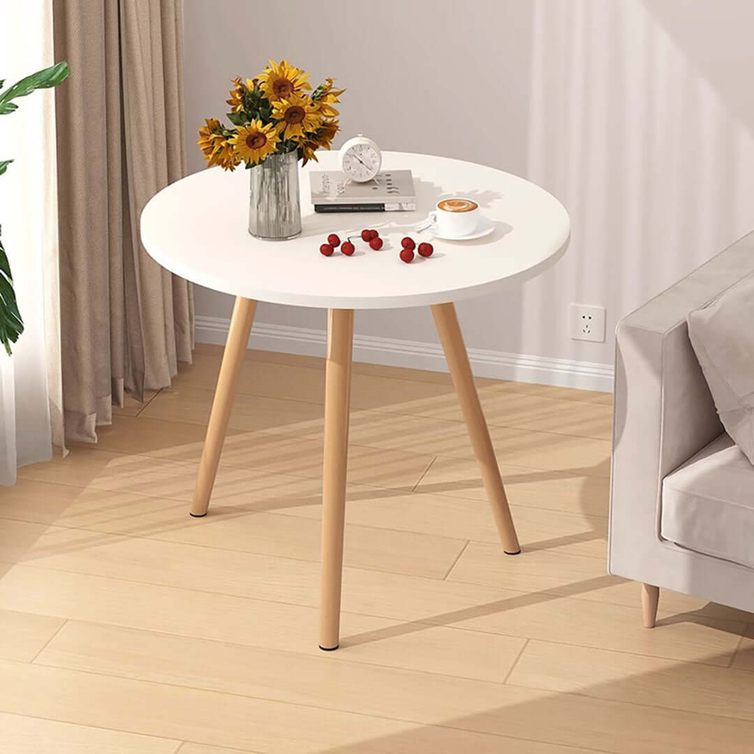 Affordable quality homewares and value furniture round white table with wooden legs decorated with flowers and accessories.