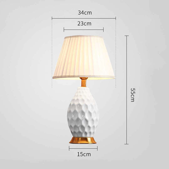 Affordable quality table lamp with textured white base and beige shade, dimensions 55cm height, and 34cm width - value homewares furniture.