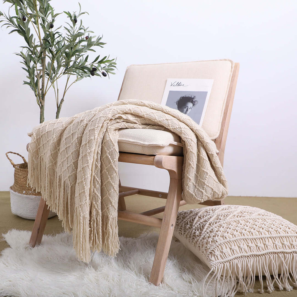 Affordable homewares featuring a value furniture chair with a cozy blanket, cushion, and a potted plant, representing quality and style.