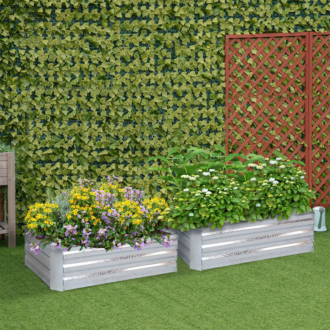 Affordable quality value homewares - gray planters with vibrant flowers and lush plants against a green ivy-covered wall and lattice background