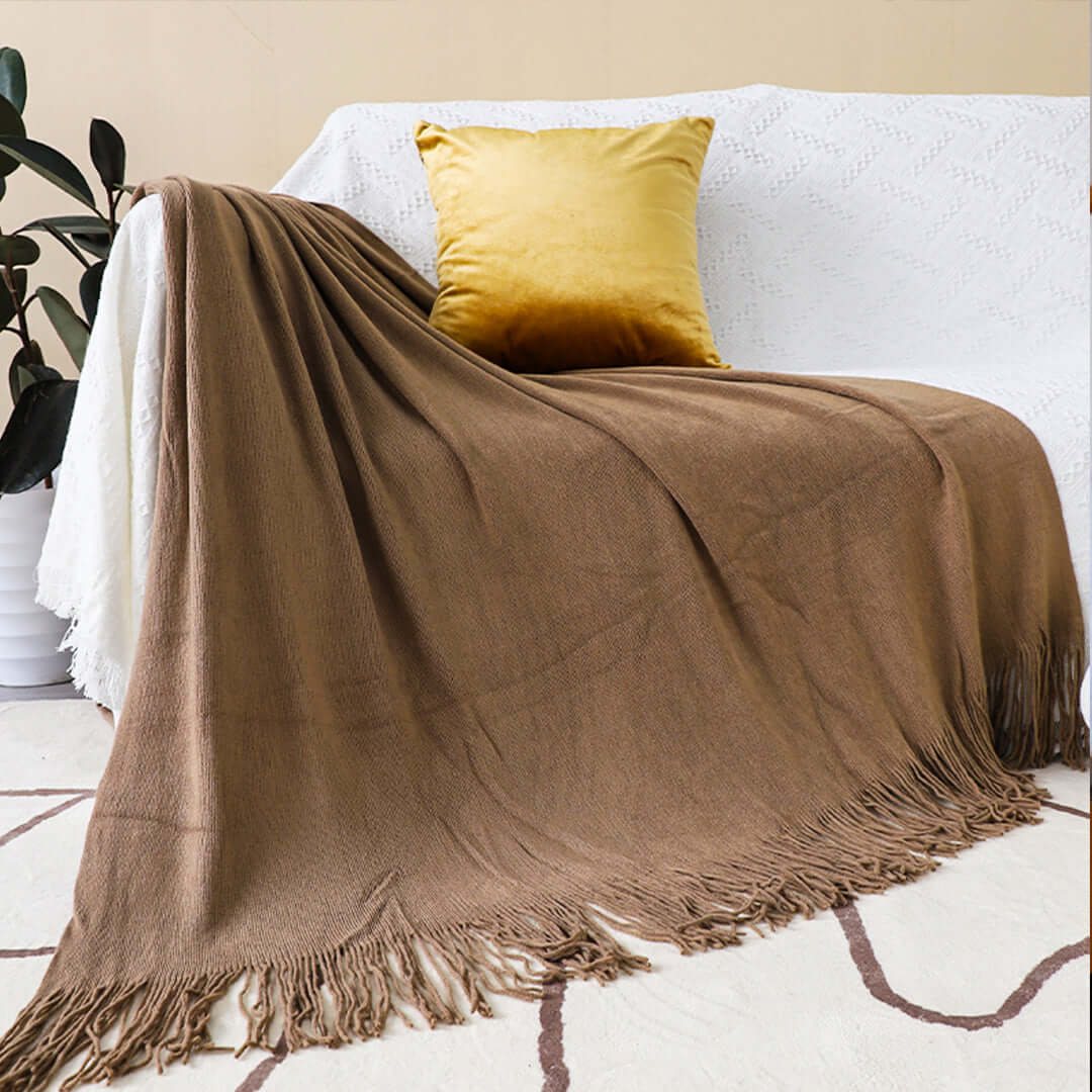 Affordable quality homewares - cozy brown throw blanket with fringe on value furniture sofa.