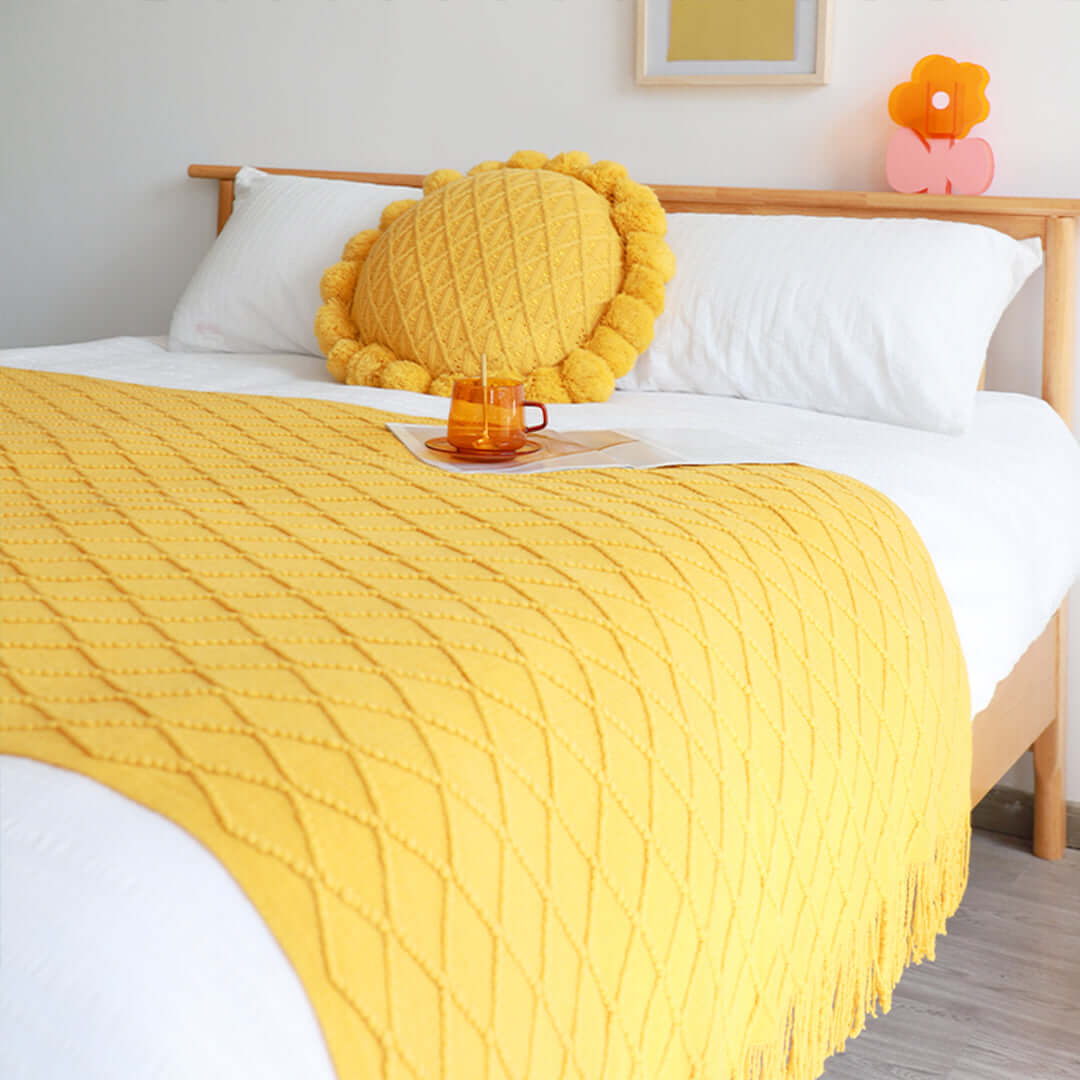 Affordable quality homewares including a yellow blanket and pillow on a value furniture bed.