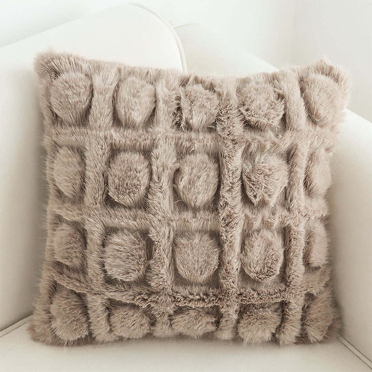 Affordable quality homewares - soft, furry beige decorative cushion showcasing unique design on comfortable white couch.