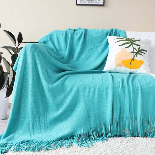 Turquoise throw blanket and cushion on a couch, showcasing affordable homewares and quality value furniture.