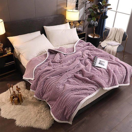 Cozy bedroom with affordable quality homewares and value furniture, featuring a luxurious purple blanket and stylish decor.