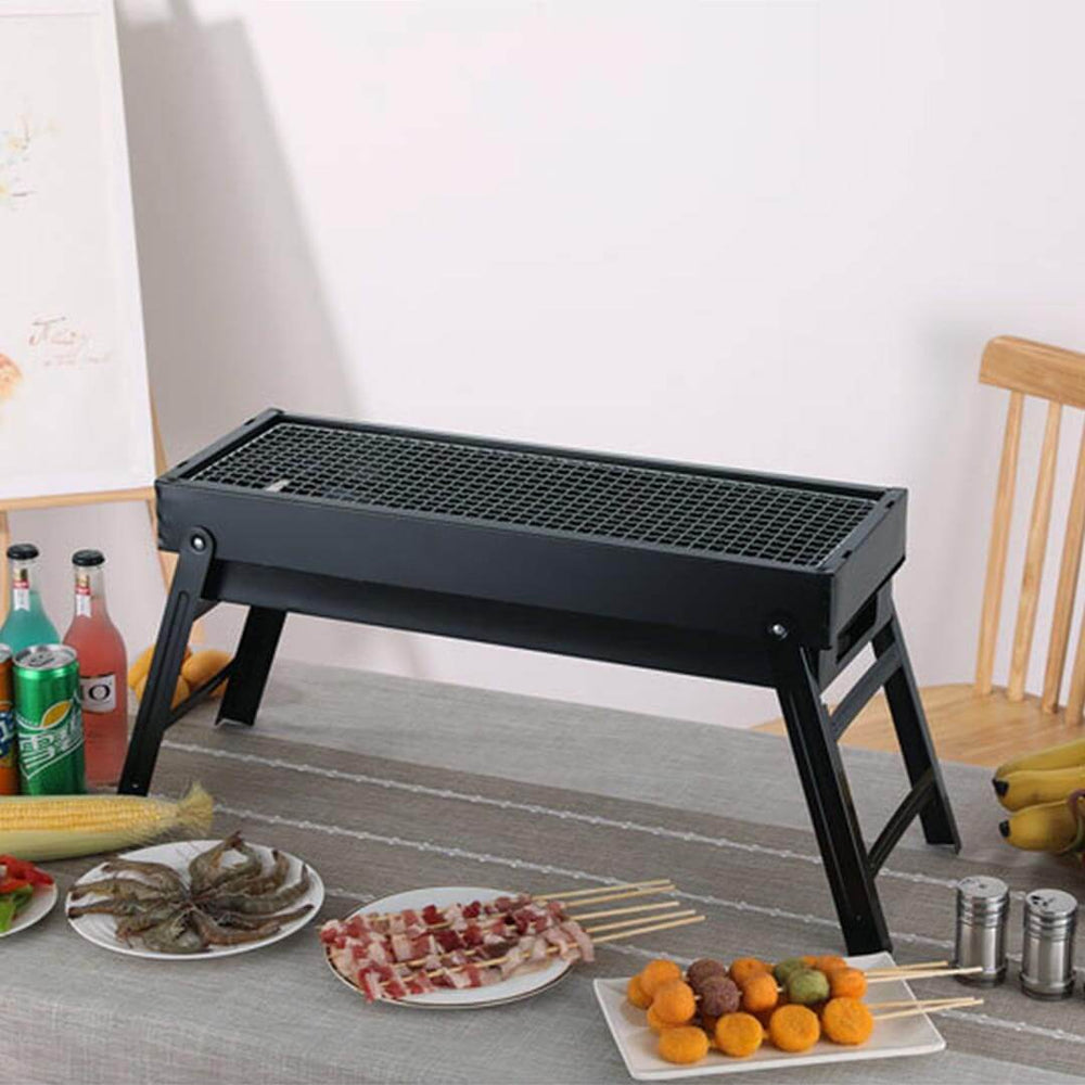 Affordable quality homewares - compact charcoal grill on a table set with skewered food, emphasizing value furniture for dining.