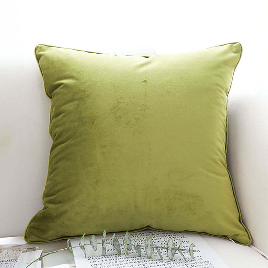 Olive green throw pillow on white couch, showcasing affordable homeware and quality value furniture.