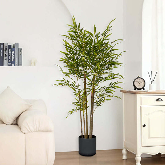 Affordable quality homewares featuring a realistic potted plant next to a sofa and a white wooden cabinet for value furniture decor.