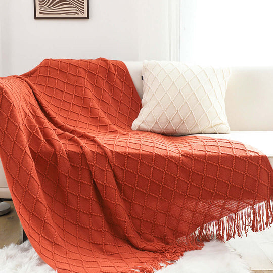 Affordable homewares include a quality, value furniture throw blanket and pillow in a stylish living room setting.