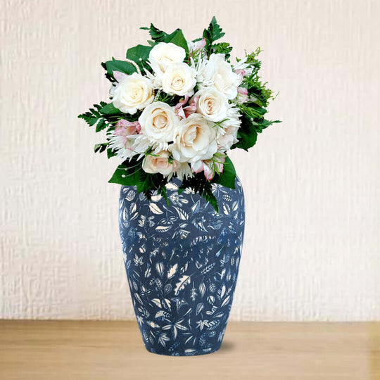 Blue floral vase with fresh white roses and greenery, showcasing affordable homewares and quality value furniture accents.