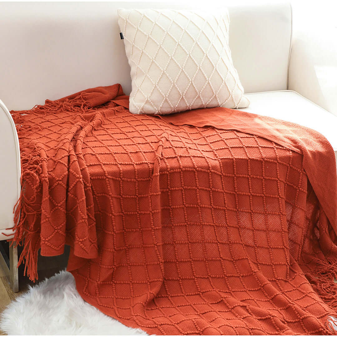 Affordable quality homewares - cozy red throw blanket and stylish white pillow on value furniture