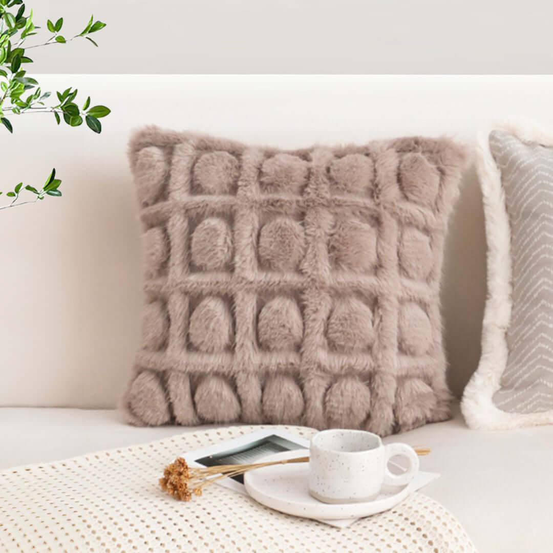 High-quality beige decorative pillow on a stylish sofa, showcasing affordable homewares and value furniture.