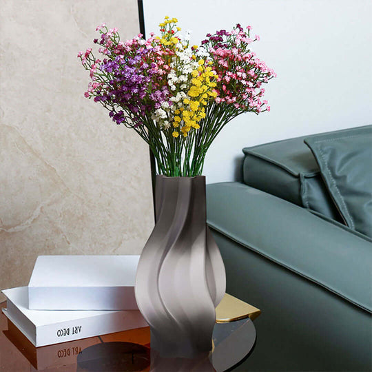 Elegant gray vase with colorful flowers on modern glass table, showcasing affordable and quality homewares for value furniture settings.