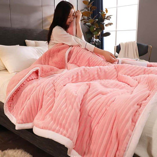 Woman enjoying a cozy pink blanket on a bed, showcasing affordable and quality homewares and value furniture.