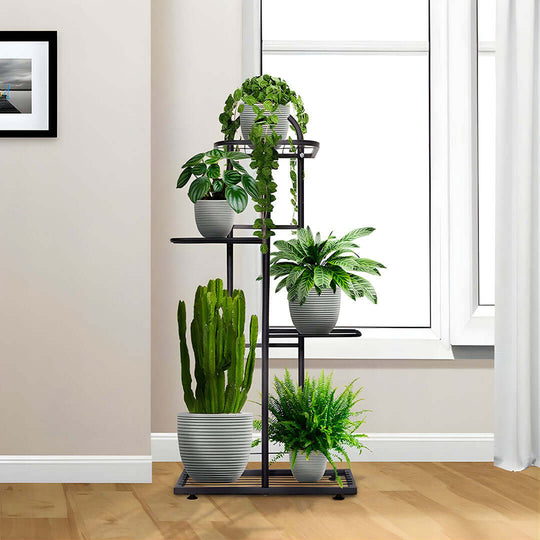 Affordable quality homewares and value furniture: Stylish metal plant stand with various potted green plants in a modern, well-lit apartment.