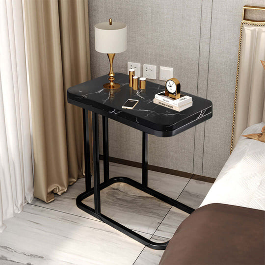 Affordable quality bedside table with a marble top, lamp, and decor items, providing value furniture for homewares enthusiasts.